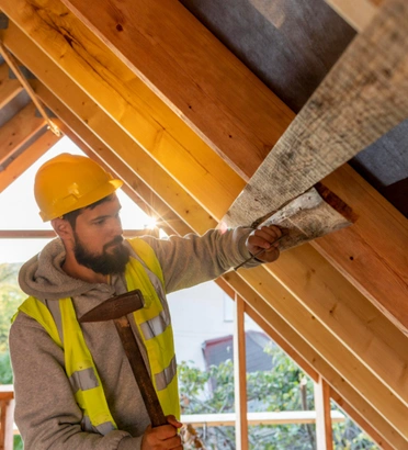 Framing Pro LA professional contractor installing wooden roof beams in Los Angeles home framing project